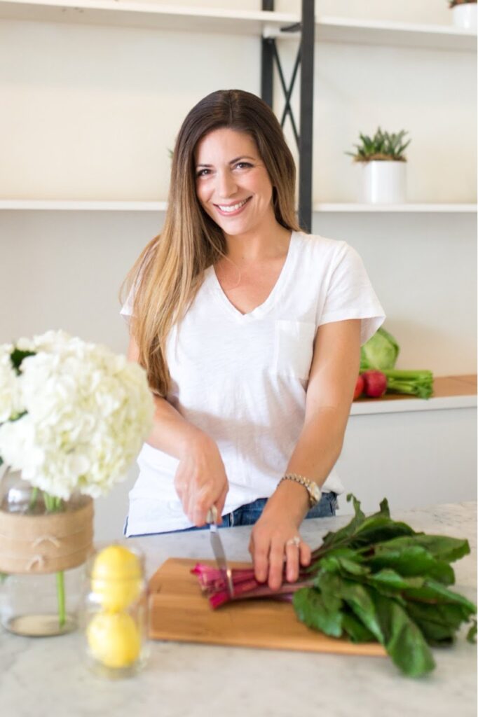 Dr. Katie Keller cutting vegitables in kitchen