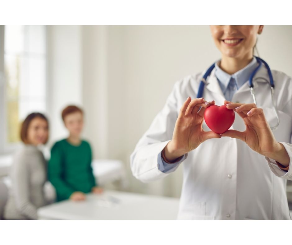 Doctor Holding Heart with Young and Healthy Couple